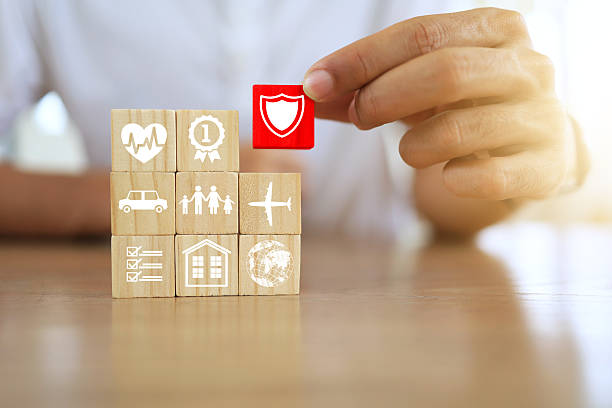 Life insurance concept with man hand in white shirt arranging wooden dice icon about health insurance and life insurance