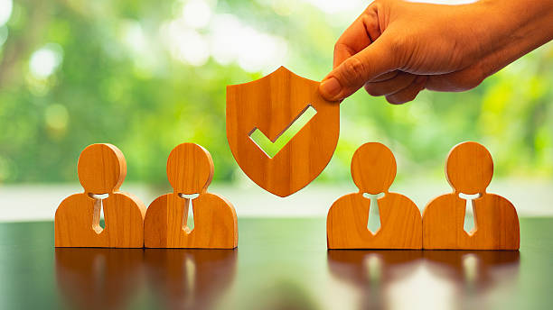 Shield icon and people model. Security protection and group  insurance. The concept of family home, protection, health care day, car insurance.